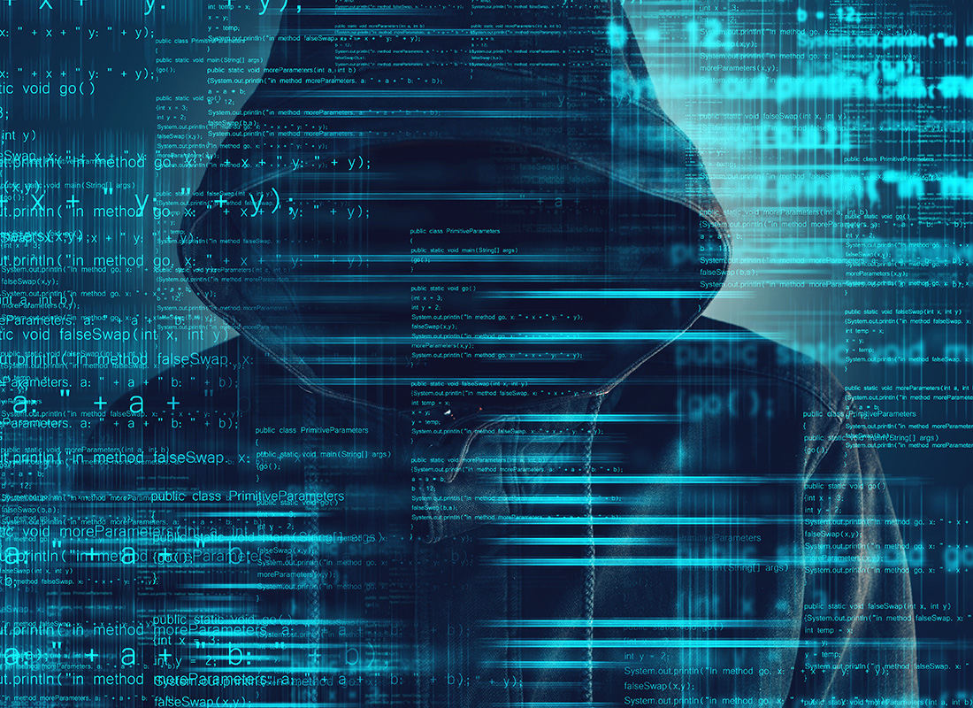 Cybersecurity, computer hacker with hoodie and obscured face, computer code overlaying image. The Cybersecurity View from ITEXPO