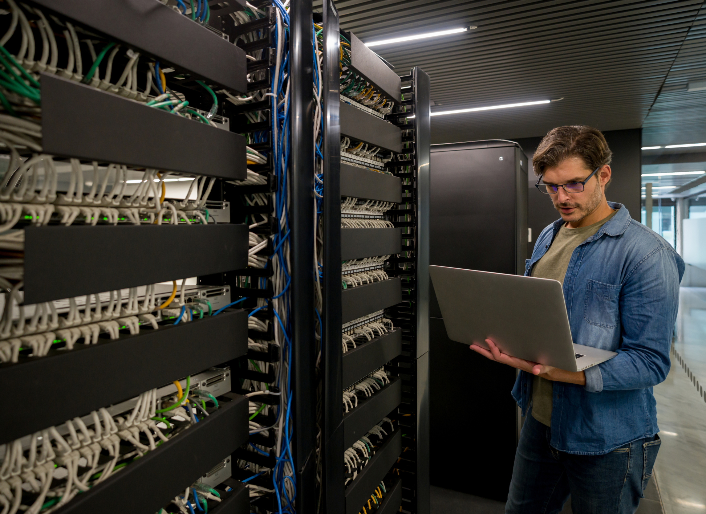 IT technician examining servers