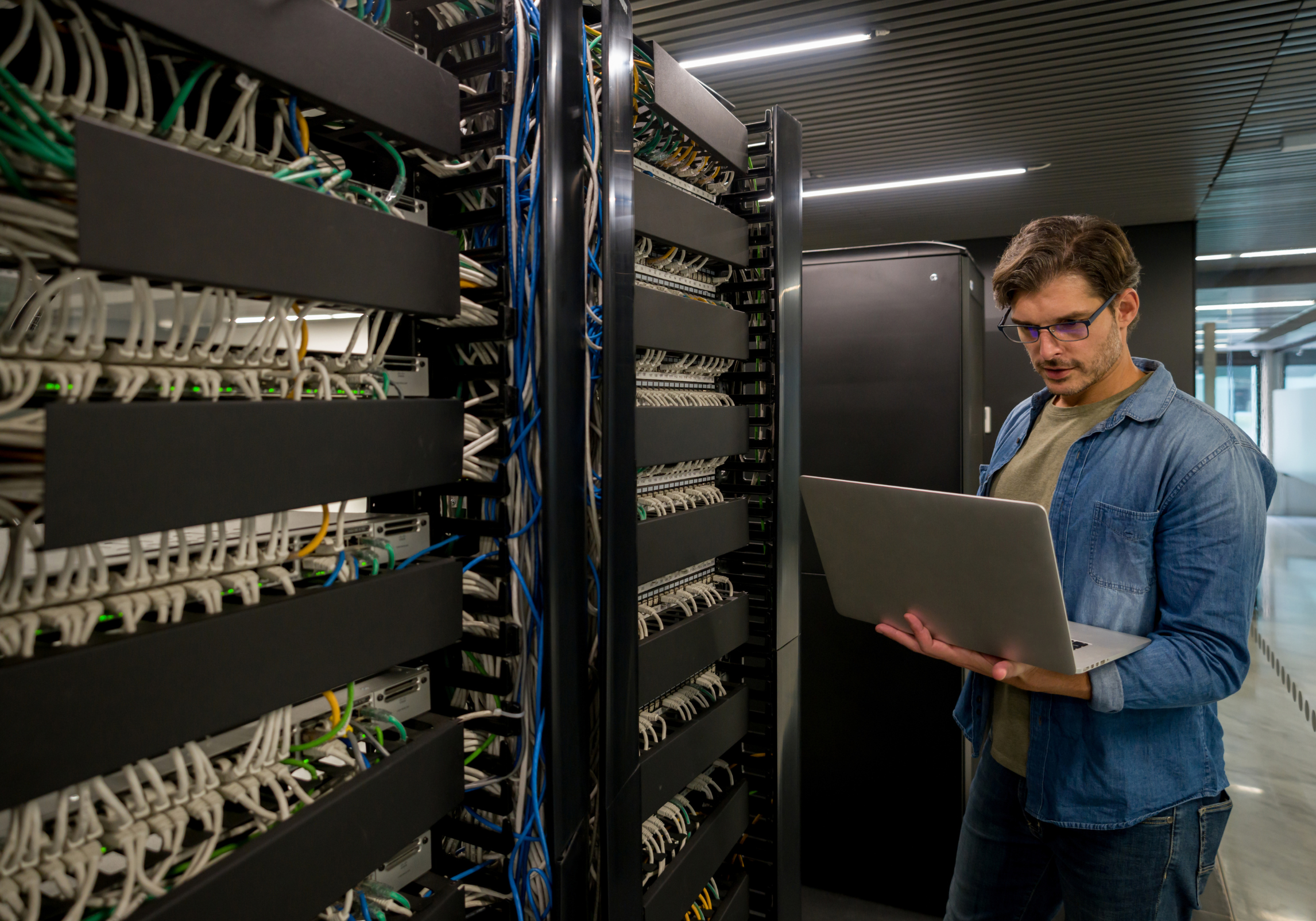 IT technician examining servers